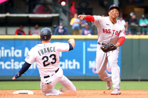 SEATTLE, WASHINGTON – SEPTEMBER 15: Rafael Devers #11 of the Boston Red Sox throws to first base after outing Ty France #23 of the Seattle Mariners to force a double play during the sixth inning at T-Mobile Park on September 15, 2021 in Seattle, Washington. (Photo by Abbie Parr/Getty Images)