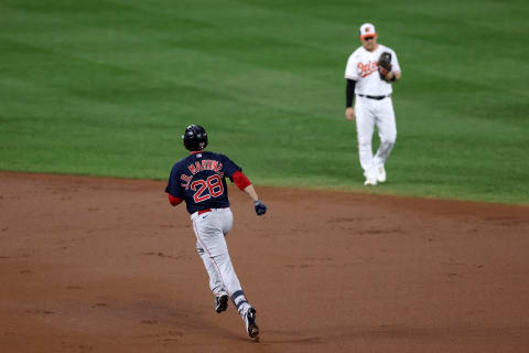 BALTIMORE, MARYLAND – SEPTEMBER 29: J.D. Martinez #28 of the Boston Red Sox rounds the bases in front of Pat Valaika #11 of the Baltimore Orioles after hitting a second inning solo home run at Oriole Park at Camden Yards on September 29, 2021 in Baltimore, Maryland. (Photo by Rob Carr/Getty Images)