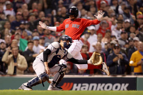 BOSTON, MASSACHUSETTS – OCTOBER 05: Xander Bogaerts #2 of the Boston Red Sox scores a run past Kyle Higashioka #66 of the New York Yankees during the sixth inning of the American League Wild Card game at Fenway Park on October 05, 2021 in Boston, Massachusetts. (Photo by Maddie Meyer/Getty Images)