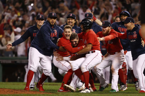 BOSTON, MASSACHUSETTS – OCTOBER 11: Enrique Hernandez #5 of the Boston Red Sox celebrates his game winning sacrifice fly with teammates in the ninth inning against the Tampa Bay Rays during Game 4 of the American League Division Series at Fenway Park on October 11, 2021 in Boston, Massachusetts. (Photo by Winslow Townson/Getty Images)