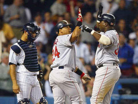 BRONX, NY – OCTOBER 8: David Ortiz #34 of the Boston Red Sox celebrates with teammate Manny Ramirez #24 after hitting a two-run home run in the top of the forth inning against the New York Yankees during game 1 of the American League Championship Series on October 8, 2003 at Yankee Stadium in the Bronx, New York. (Photo by Al Bello/Getty Images)