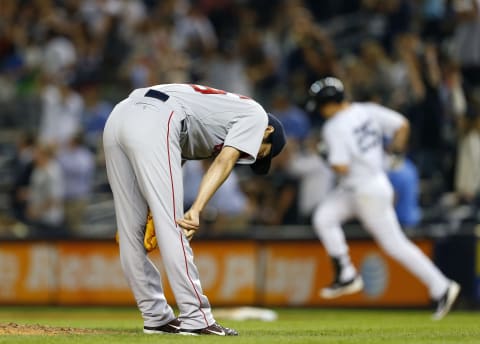 NEW YORK, NY – SEPTEMBER 04: Koji Uehara #19 of the Boston Red Sox reacts after giving up a game tying homerun to Mark Teixeira #25 of the New York Yankees who round first base during the ninth inning in a MLB baseball game at Yankee Stadium on September 4, 2014 in the Bronx borough of New York City. (Photo by Rich Schultz/Getty Images)