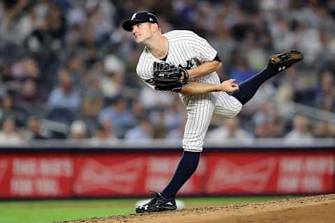 NEW YORK, NEW YORK – OCTOBER 09: David Robertson #30 of the New York Yankees pitches in the sixth inning against the Boston Red Sox during Game Four American League Division Series at Yankee Stadium on October 09, 2018 in the Bronx borough of New York City. (Photo by Elsa/Getty Images)