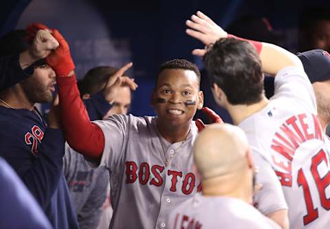 TORONTO, ON – MAY 22: Rafael Devers #11 of the Boston Red Sox is congratulated by teammates in the dugout after hitting a solo home run in the eighth inning during MLB game action against the Toronto Blue Jays at Rogers Centre on May 22, 2019 in Toronto, Canada. (Photo by Tom Szczerbowski/Getty Images)