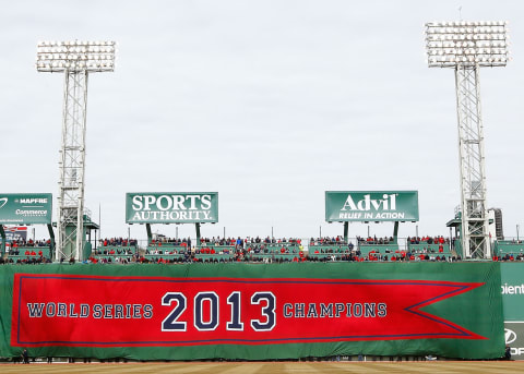 BOSTON, MA – APRIL 04: The 2013 World Series Champions Boston Red Sox banner is draped across the Green Monster prior to the Opening Day game between the Boston Red Sox and the Milwaukee Brewers at Fenway Park on April 4, 2014 in Boston, Massachusetts. (Photo by Jared Wickerham/Getty Images)