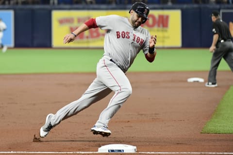 ST. PETERSBURG, FLORIDA – JULY 23: J.D. Martinez #28 of the Boston Red Sox rounds third after teammate Andrew Benintendi #16 hit an RBI single in the first inning of a baseball game against the Tampa Bay Rays at Tropicana Field on July 23, 2019 in St. Petersburg, Florida. (Photo by Julio Aguilar/Getty Images)