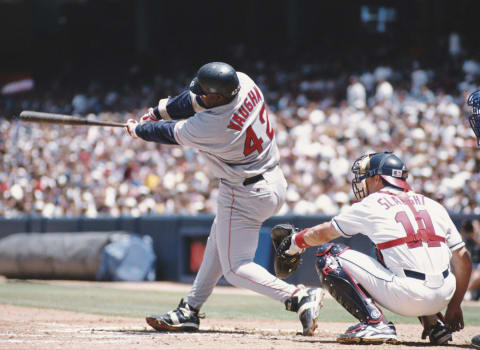 Don Slaught, Catcher for the California Angels sits behind the plate as Mo Vaughn, First Baseman for the Boston Red Sox swings at the ball during the Major League Baseball American League West game against the California Angels on 26 May 1996 at Anaheim Stadium, Anaheim, California, United States. The Angels won the game 12 – 2. (Photo by Stephen Dunn/Allsport/Getty Images)