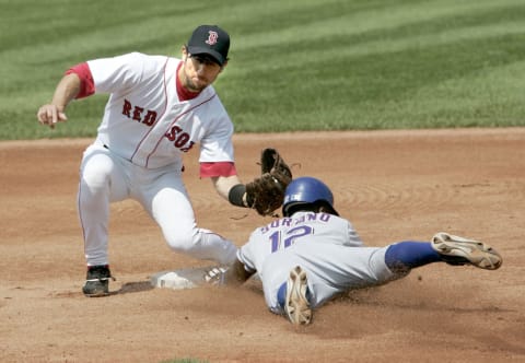 Boston Red Sox shortstop Nomar Garciaparra makes the tag on a sliding Texas Rangers base runner Alfonso Soriano. The Rangers beat the Red Sox 6-5 at Fenway Park in Boston Massachusetts on July 11, 2004. (Photo by J Rogash/Getty Images)