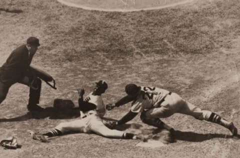 CHICAGO – 1953. Minnie Minoso makes a perfect slide around Boston Red Sox catcher Sammy White during a game at Comiskey Park in Chicago in 1953. (Photo by Mark Rucker/Transcendental Graphics, Getty Images)