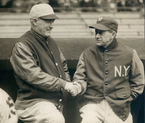 UNSPECIFIED – 1929: New York Yankee manager Miller Huggins shaking hands with Boston Red Sox manager Bill Carrigan. (Sports Studio Photos/Getty Images)