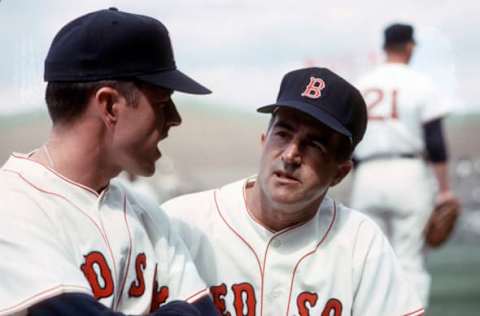 BOSTON, MA – CIRCA 1963: Manager Johnny Pesky #22 of the Boston Red Sox talks with first baseman Dick Stuart #7 during an Major League Baseball game circa 1963 at Fenway Park in Boston, Massachusetts. Pesky managed the Red Sox from 1963-64 and 1980. (Photo by Focus on Sport/Getty Images)