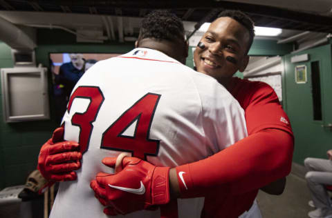 BOSTON, MA - SEPTEMBER 9: Former designated hitter David Ortiz #34 of the Boston Red Sox greets Rafael Devers #11 of the Boston Red Sox before throwing out a ceremonial first pitch as he returns to Fenway Park before a game against the New York Yankees on September 9, 2019 at Fenway Park in Boston, Massachusetts. (Photo by Billie Weiss/Boston Red Sox/Getty Images)