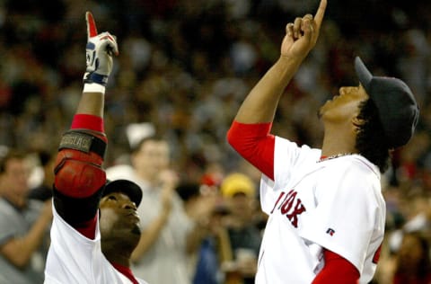 Boston Red Sox pitcher Pedro Martinez, right, and teammate David Ortiz point skyward after Martinez completed seven innings with a 4-1 lead against the Los Angeles Dodgers at Fenway Park in Boston, Saturday, June 13, 2004. (Photo by J Rogash/Getty Images)