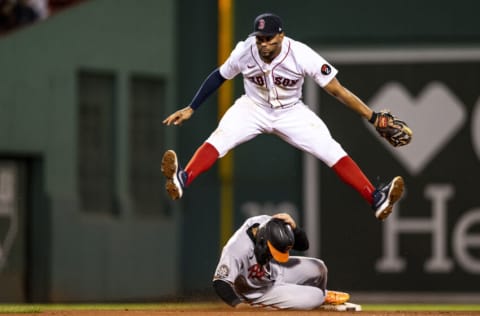 BOSTON, MA - SEPTEMBER 27: Xander Bogaerts #2 of the Boston Red Sox leaps as he turns a double pay over Rougned Odor #12 of the Baltimore Orioles during the ninth inning of a game on September 27, 2022 at Fenway Park in Boston, Massachusetts. (Photo by Billie Weiss/Boston Red Sox/Getty Images)