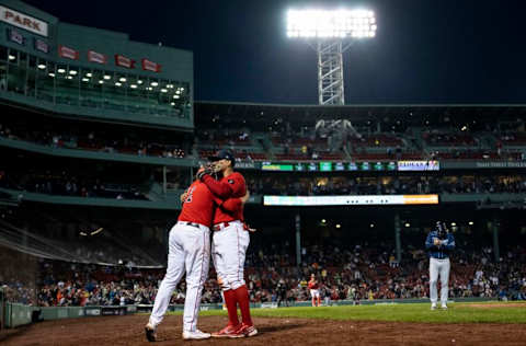 BOSTON, MA - OCTOBER 5: Xander Bogaerts #2 of the Boston Red Sox hugs Rafael Devers #11 as he exits the game during the seventh inning of a game against the Tampa Bay Rays on October 5, 2022 at Fenway Park in Boston, Massachusetts. (Photo by Billie Weiss/Boston Red Sox/Getty Images)