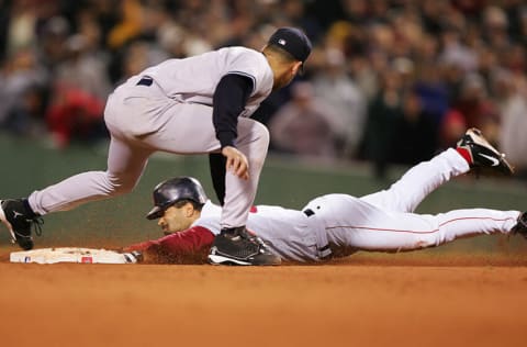 BOSTON - OCTOBER 17: Dave Roberts #31 of the Boston Red Sox steals second base while shortstop Derek Jeter #2 of the New York Yankees applies the tag in the ninth inning during game four of the American League Championship Series on October 17, 2004 at Fenway Park in Boston, Massachusetts. (Photo by Jed Jacobsohn/Getty Images)