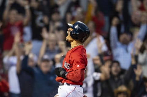 BOSTON, MA - SEPTEMBER 29: Mookie Betts #50 of the Boston Red Sox reacts after scoring the game winning run on a walk-off single hit by Rafael Devers #11 during the ninth inning of a game against the Baltimore Orioles on September 29, 2019 at Fenway Park in Boston, Massachusetts. (Photo by Billie Weiss/Boston Red Sox/Getty Images)