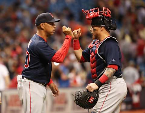 Mar 30, 2018; St. Petersburg, FL, USA;Boston Red Sox manager Alex Cora (20) congratulates catcher Christian Vazquez (7) as they beat the Tampa Bay Rays at Tropicana Field. Mandatory Credit: Kim Klement-USA TODAY Sports