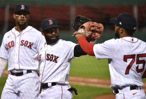 Sep 19, 2020; Boston, Massachusetts, USA; Boston Red Sox center fielder Jackie Bradley Jr. (19) congratulates right fielder CŽsar Puello (75) after making a play during the third inning against the New York Yankees at Fenway Park. Mandatory Credit: Bob DeChiara-USA TODAY Sports