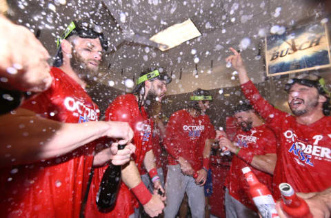 Oct 8, 2022; St. Louis, Missouri, USA; Members of the Philadelphia Phillies celebrate in the clubhouse following their 2-0 victory against the St. Louis Cardinals during game two of the Wild Card series for the 2022 MLB Playoffs at Busch Stadium. Mandatory Credit: Jeff Curry-USA TODAY Sports