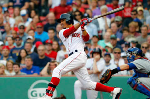 Apr 29, 2017; Boston, MA, USA; Boston Red Sox right fielder Mookie Betts (50) hits a single against the Chicago Cubs during the eighth inning at Fenway Park. Mandatory Credit: Winslow Townson-USA TODAY Sports