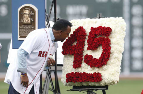 Jul 29, 2015; Boston, MA, USA; Hall of Fame player Pedro Martinez stops to smell the roses during his number retirement ceremony performed in Spanish before the game between the Chicago White Sox and the Boston Red Sox at Fenway Park. Mandatory Credit: Greg M. Cooper-USA TODAY Sports