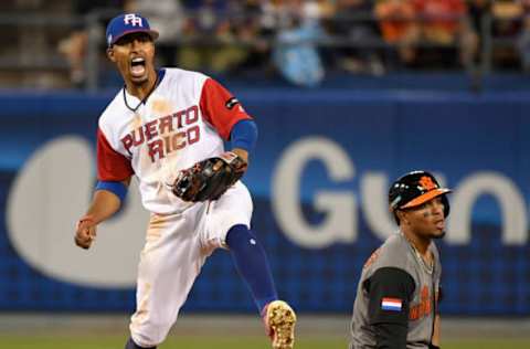 Mar 20, 2017; Los Angeles, CA, USA; Puerto Rico shortstrop Francisco Lindor (12) celebrates after forcing out Netherlands infielder Xander Bogaerts (1) to start a double play during the 2017 World Baseball Classic at Dodger Stadium. Mandatory Credit: Robert Hanashiro-USA TODAY Sports