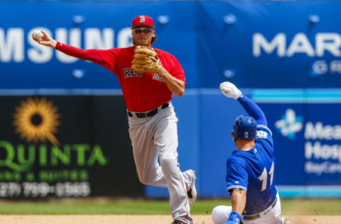 Mar 24, 2017; Dunedin, FL, USA; Boston Red Sox second baseman Josh Rutledge (32) throws to first for a double play as Toronto Blue Jays center fielder Kevin Pillar (11) slides into second base in the fourth inning of a baseball game during spring training at Florida Auto Exchange Stadium. Mandatory Credit: Butch Dill-USA TODAY Sports