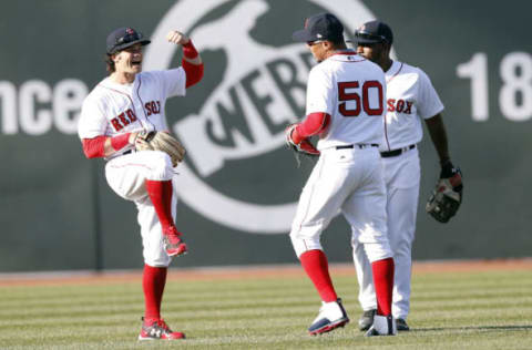 Apr 3, 2017; Boston, MA, USA; Boston Red Sox left fielder Andrew Benintendi (16) celebrates with center fielder Jackie Bradley Jr. (19) and right fielder Mookie Betts (50) during the ninth inning at Fenway Park. The Boston Red Sox won 5-3. Mandatory Credit: Greg M. Cooper-USA TODAY Sports