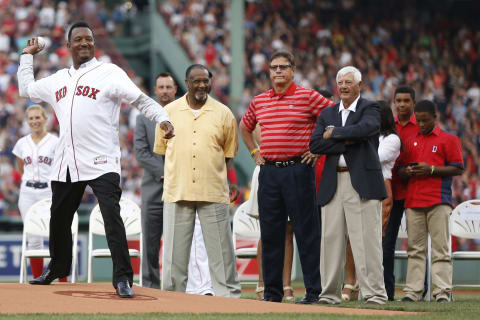 Jul 28, 2015; Boston, MA, USA; Hall of Fame player Pedro Martinez throws out the first pitch under the watchful eye of former Boston Red Sox players Tim Wakefield, (left) Jim Rice, Carlton Fisk and Carl Yastrzemsk during his number retirement ceremony before the game against the Chicago White Sox at Fenway Park. Mandatory Credit: Greg M. Cooper-USA TODAY Sports