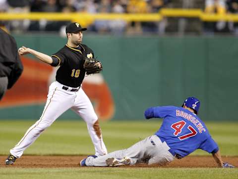 Sep 14, 2013; Pittsburgh, PA, USA; Pittsburgh Pirates second baseman Neil Walker (18) turns a game ending double play over Chicago Cubs right fielder Brian Bogusevic (47) during the ninth inning at PNC Park. The Pittsburgh Pirates won 2-1. Mandatory Credit: Charles LeClaire-USA TODAY Sports