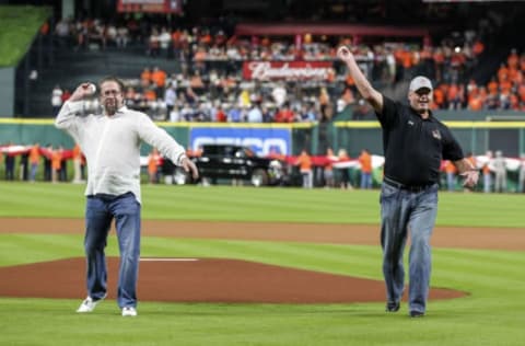 Houston Astros former players Jeff Bagwell (left) and Roger Clemens (right) throw out a ceremonial first pitch before a game against the Kansas City Royals at Minute Maid Park.