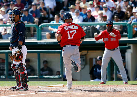 Mar 3, 2017; Lake Buena Vista, FL, USA; Boston Red Sox right fielder Rusney Castillo (right) waves to slow down Boston Red Sox third baseman Deven Marrero (17)scores as Atlanta Braves catcher Kurt Suzuki (left) waits for the ball during the fourth inning of an MLB spring training baseball game at Champion Stadium. Mandatory Credit: Reinhold Matay-USA TODAY Sports