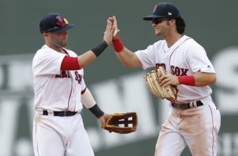 Apr 16, 2017; Boston, MA, USA; Boston Red Sox second baseman Dustin Pedroia (15) congratulates left fielder Andrew Benintendi (16) after defeating the Tampa Bay Rays 7-5 at Fenway Park. Mandatory Credit: Greg M. Cooper-USA TODAY Sports