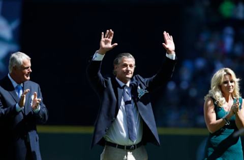 Aug 8, 2015; Seattle, WA, USA; Former Seattle Mariners manager Lou Piniella (left) and wife Karen Moyer (right) clap as former Seattle Mariners pitcher Jamie Moyer is inducted into the Mariners Hall of Fame before the start of a game Texas Rangers at Safeco Field. Mandatory Credit: Jennifer Buchanan-USA TODAY Sports