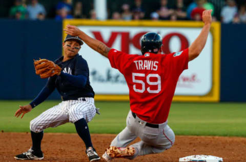 Mar 21, 2017; Tampa, FL, USA; Boston Red Sox first baseman Sam Travis (59) is tagged out by New York Yankees third baseman Ronald Torreyes (74) as he tries to steal second base in the third inning of a baseball game during spring training at George M. Steinbrenner Field. Mandatory Credit: Butch Dill-USA TODAY Sports