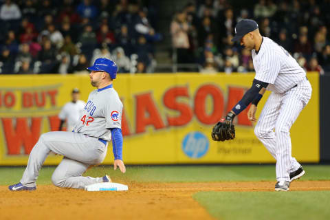 Apr 16, 2014; Bronx, NY, USA; Chicago Cubs center fielder Ryan Kalish (51) steals second as New York Yankees shortstop Derek Jeter (2) is late with the tag during the third inning at Yankee Stadium. Mandatory Credit: Anthony Gruppuso-USA TODAY Sports