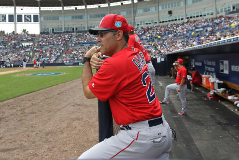 Mar 5, 2016; Tampa, FL, USA; Boston Red Sox first base coach Ruben Amaro (20) calls signals from the dugout against the New York Yankees at George M. Steinbrenner Field. Mandatory Credit: Kim Klement-USA TODAY Sports