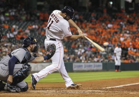 Aug 19, 2015; Houston, TX, USA; Houston Astros designated hitter Evan Gattis (11) hits a single during the fourth inning against the Tampa Bay Rays at Minute Maid Park. Mandatory Credit: Troy Taormina-USA TODAY Sports