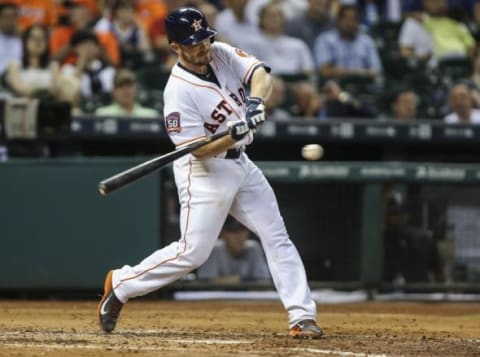 Sep 1, 2015; Houston, TX, USA; Houston Astros catcher Max Stassi (12) hits an RBI single during the second inning against the Seattle Mariners at Minute Maid Park. Mandatory Credit: Troy Taormina-USA TODAY Sports