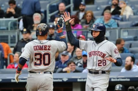 Apr 7, 2016; Bronx, NY, USA; Houston Astros left fielder Colby Rasmus (28) and center fielder Carlos Gomez (30) celebrate after scoring against the New York Yankees during the fourth inning at Yankee Stadium. Mandatory Credit: Anthony Gruppuso-USA TODAY Sports