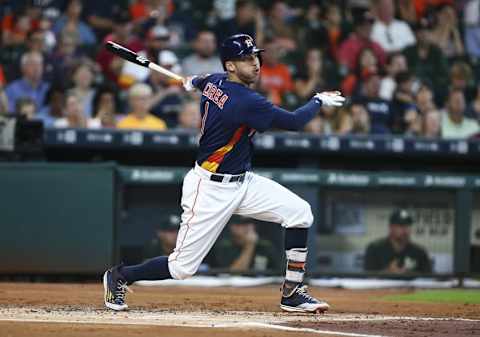 Jul 10, 2016; Houston, TX, USA; Houston Astros shortstop Carlos Correa (1) hits a single during the first inning against the Oakland Athletics at Minute Maid Park. Mandatory Credit: Troy Taormina-USA TODAY Sports