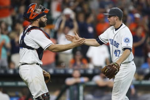 Jun 19, 2016; Houston, TX, USA; Houston Astros catcher Evan Gattis (11) and relief pitcher Chris Devenski (47) celebrate after defeating the Cincinnati Reds 6-0 at Minute Maid Park. Mandatory Credit: Troy Taormina-USA TODAY Sports