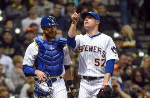 Apr 8, 2016; Milwaukee, WI, USA; Milwaukee Brewers pitcher Chase Anderson (57) talks to catcher Jonathan Lucroy (20) after getting Houston Astros left fielder Colby Rasmus (not pictured) to foul out to Lucroy in the fifth inning at Miller Park. Anderson pitched five scoreless innings to pick up the win as the Brewers beat the Astros 6-4. Mandatory Credit: Benny Sieu-USA TODAY Sports