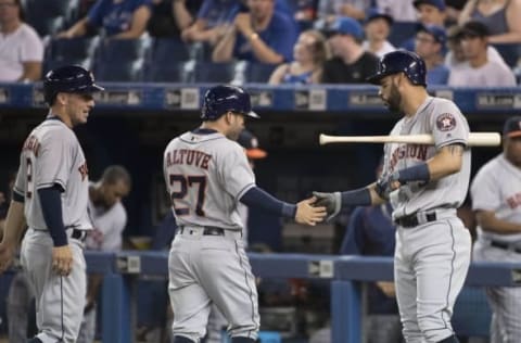 Aug 13, 2016; Toronto, Ontario, CAN; Houston Astros second baseman Jose Altuve (27) and third baseman Alex Bregman (2) celebrate scoring runs with Houston Astros first baseman Marwin Gonzalez (9) during the first inning in a game against the Toronto Blue Jays at Rogers Centre. Mandatory Credit: Nick Turchiaro-USA TODAY Sports