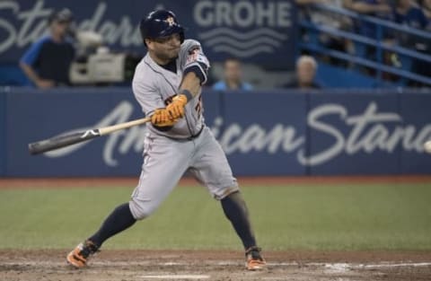 Aug 13, 2016; Toronto, Ontario, CAN; Houston Astros second baseman Jose Altuve (27) hits a triple during the eighth inning in a game against the Toronto Blue Jays at Rogers Centre. Toronto Blue Jays won 4-2. Mandatory Credit: Nick Turchiaro-USA TODAY Sports