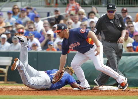 Mar 5, 2016; Kissimmee, FL, USA; New York Mets first baseman Dominic Smith (74) dives back into first base as Houston Astros first baseman A.J. Reed (80) attempts a tag during the second inning of a spring training baseball game at Osceola County Stadium. Mandatory Credit: Reinhold Matay-USA TODAY Sports