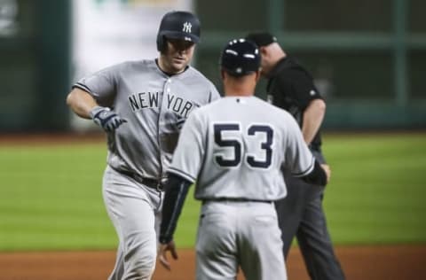 Jul 27, 2016; Houston, TX, USA; New York Yankees catcher Brian McCann (34) celebrates with third base coach Joe Espada (53) after hitting a home run against the Houston Astros during the fourth inning at Minute Maid Park. Mandatory Credit: Troy Taormina-USA TODAY Sports