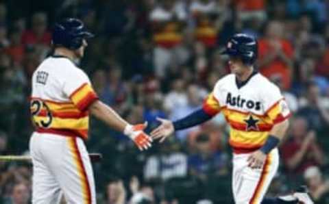 Aug 6, 2016; Houston, TX, USA; Houston Astros third baseman Alex Bregman (2) celebrates with first baseman A.J. Reed (23) after scoring a run during the first inning against the Texas Rangers at Minute Maid Park. Mandatory Credit: Troy Taormina-USA TODAY Sports