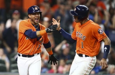 Sep 23, 2016; Houston, TX, USA; Houston Astros third baseman Yulieski Gurriel (10) and shortstop Carlos Correa (1) celebrate after scoring runs during the sixth inning against the Los Angeles Angels at Minute Maid Park. Mandatory Credit: Troy Taormina-USA TODAY Sports